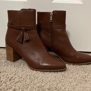 Brown ankle boots with tassel detail.